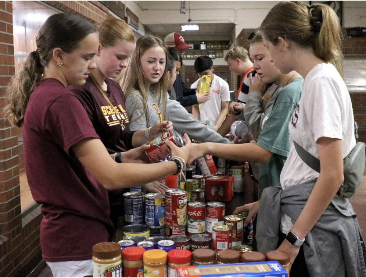 Science Hill Tennis Team helping to sort the abundance of canned goods donations